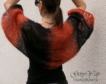 May include: A black and orange ombre knit shrug with a loose fit and long sleeves. The shrug is made of a soft, lightweight yarn and has a delicate, openwork design.
