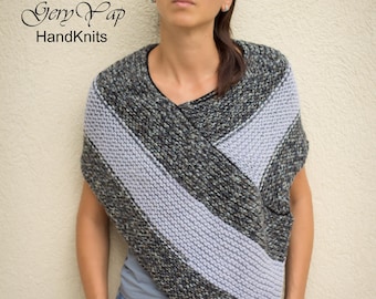 May include: A grey and light blue knitted poncho with a diagonal striped pattern. The poncho is being worn by a person with dark hair and sunglasses. The text "Gery Yap HandKnits" is visible in the image.