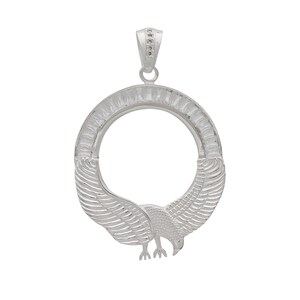 May include: A silver-colored pendant featuring an eagle design. The pendant has a circular frame with an eagle at the bottom, wings spread. The top has a small loop with embedded stones for a chain.