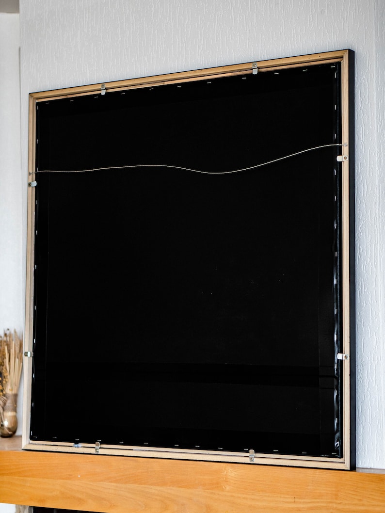 rear part of the painting with the hanging hook and stripe