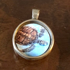 Sea turtle pendant in antiqued bronze bezel