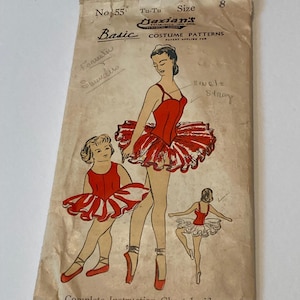 May include: A vintage Dazian's No. 55 Tu-Tu costume pattern envelope in size 8. The beige paper envelope features illustrations of dancers in red and white tutus, with handwritten notes and the text 'Basic COSTUME PATTERNS' and 'Complete Instruction Chart Inside'.