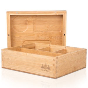 May include: A light brown bamboo box with an open lid. The lid has a circular indentation and a rectangular indentation. The box has several compartments inside. The words "HAPPY TREES" and a tree logo are printed on the front.