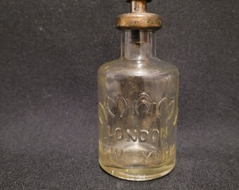 Vintage glazen AMAMI-parfumflesje