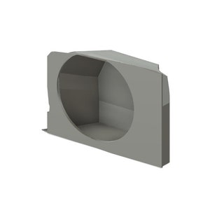 May include: A gray, angular, three-dimensional object with a large circular opening. The object has a box-like structure with a flat base and a sloped top. The overall design is geometric and modern.