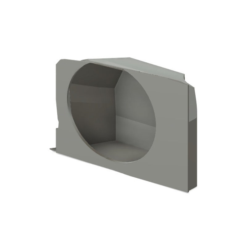 May include: A gray, angular, three-dimensional object with a large circular opening. The object has a box-like structure with a flat base and a sloped top. The overall design is geometric and modern.