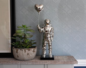 Spaceman Holding Love Heart Balloon