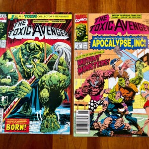 May include: Two vintage "The Toxic Avenger" comic books. The first issue features a green monster with the text "BORN!". The second comic book cover has the text "APOCALYPSE, INC!" and "MUTANT MONSTERS!" with various monster illustrations.
