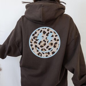 leopard smiley face hoodie | trendy women&#39;s hoodie, trendy sweatshirt, brown hoodie, brown hoodie, hoodie with words on back