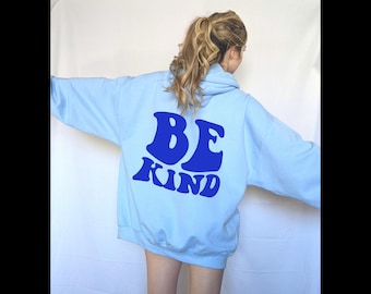 Könnte beinhalten: Ein hellblauer Hoodie mit einem blauen "BE KIND"-Motiv auf der Rückseite.