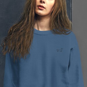 May include: A blue sweatshirt with a small embroidered dachshund on the front.