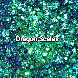 May include: Close-up of teal, green, and blue glitter with a holographic finish. The glitter is arranged in a random pattern and has a sparkly appearance. The text "Dragon Scales" is printed in white on the glitter.