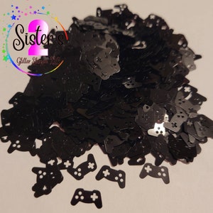 May include: Black glitter shaped like video game controllers.