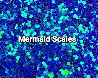 May include: Close-up of blue and green iridescent glitter, with the text "Mermaid Scales" in white.