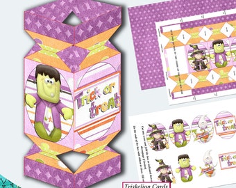 May include: A four-sided Halloween cracker-shaped treat box with a Frankenstein character illustration and the text "Trick or Treat." The box is purple, orange, and green with a diamond pattern. Additional printed sheets with Halloween characters are also visible.