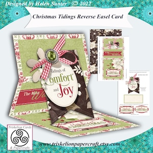 May include: A printable digital download for a Christmas card featuring a reverse easel design. The card features a brown and green color scheme with a red and white gingham bow. The text on the card reads "Tidings of comfort and joy".