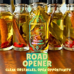 May include: Five small glass bottles filled with a yellow liquid and various herbs and spices. The bottles are labeled "Road Opener" and "The Magick Lab".