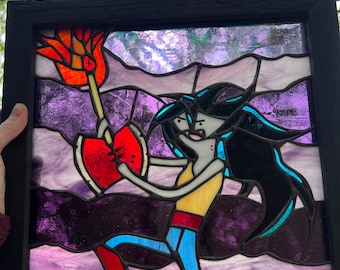 May include: A stained glass window depicting a cartoon character holding a flaming heart and a torch. The character has black hair, a yellow shirt, blue jeans, and red boots. The background is a purple and blue sky with clouds.
