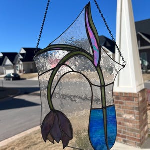 Handmade stained glass sun catcher titled “droopy tulip”.