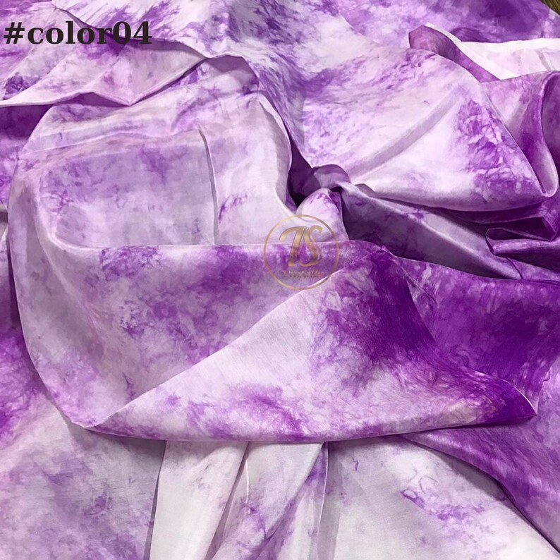 May include: Purple and white tie-dye fabric with a white background and purple tie-dye pattern. #color04