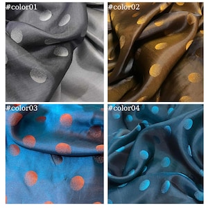 May include: Four fabric swatches with different colored polka dots. The swatches are arranged in a grid with the top left swatch being gray with silver polka dots, the top right swatch being brown with gold polka dots, the bottom left swatch being blue with orange polka dots, and the bottom right swatch being teal with blue polka dots.