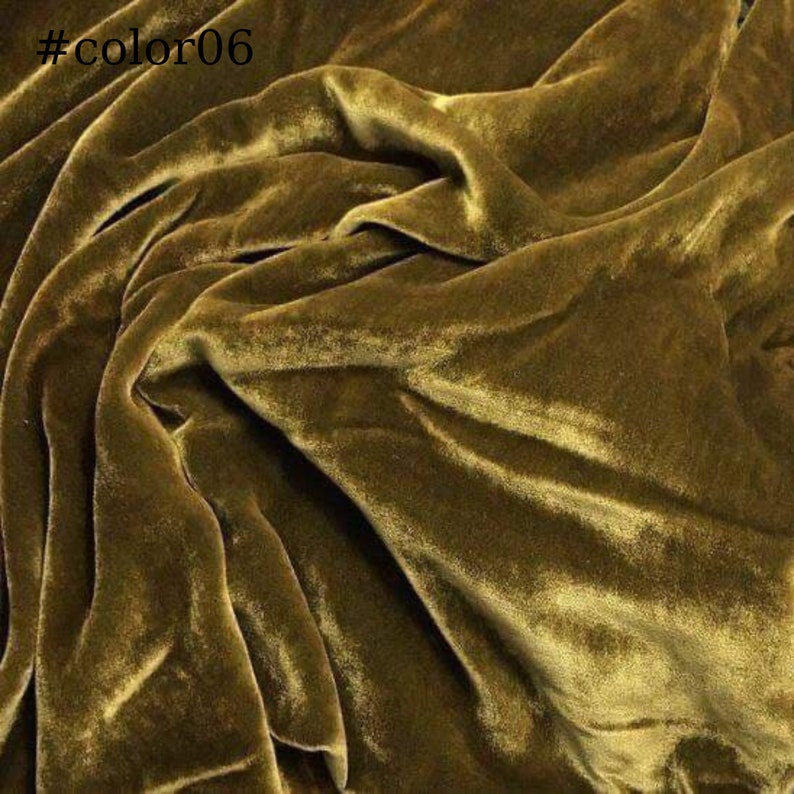 May include: A close-up of a soft, luxurious, golden brown velvet fabric. The fabric is smooth and has a subtle sheen.