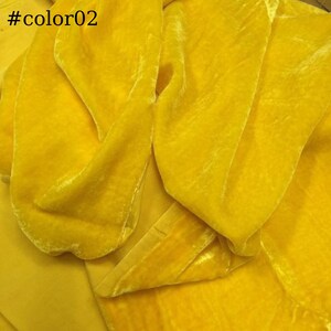 May include: A close-up of a bright yellow velvet fabric. The fabric is soft and has a subtle sheen.