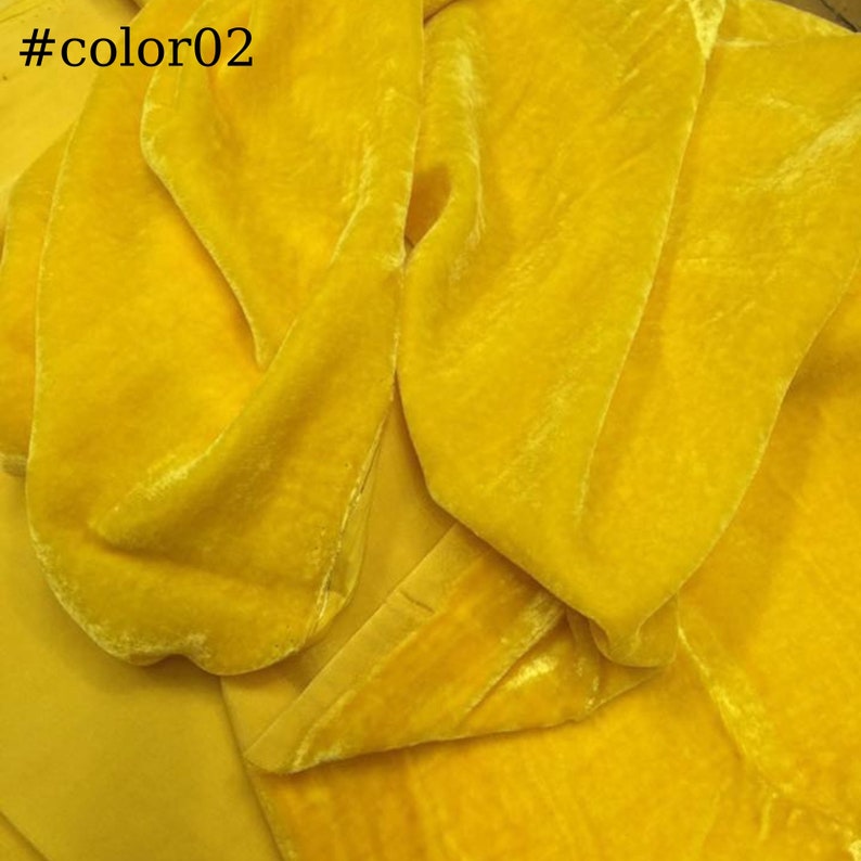 May include: A close-up of a bright yellow velvet fabric. The fabric is soft and has a subtle sheen.