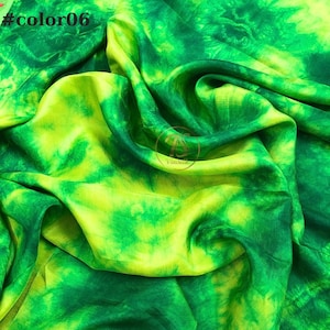 May include: Green and yellow tie-dye fabric with a swirling pattern. The fabric is soft and flowing, and the colors are vibrant.