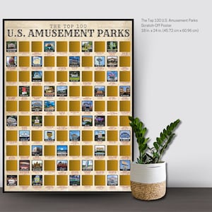 May include: A framed scratch-off poster titled "The Top 100 U.S. Amusement Parks." The poster is 18 x 24 inches and features a grid of gold squares, each representing a park. The text "U.S. AMUSEMENT PARKS" is at the top.