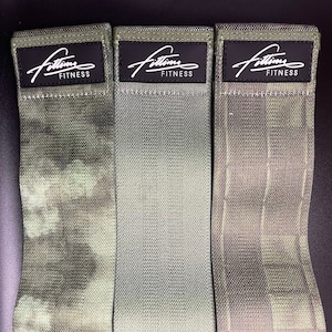 May include: Three green and white patterned fabric resistance bands with black labels that read "Fittim Fitness".
