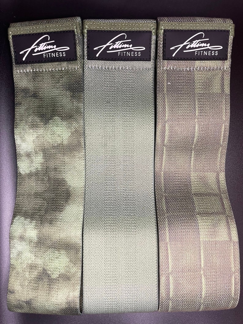 May include: Three green and white patterned fabric resistance bands with black labels that read "Fittim Fitness".