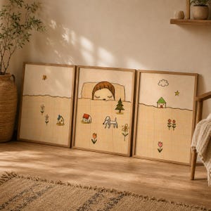 May include: A set of three framed wall art prints featuring a grid pattern background in light yellow. The illustrations depict a person sleeping in bed, small houses, a dog, flowers, a tree, a butterfly, a cloud, and a star in simple line art.