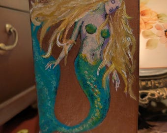 Painting of a mermaid with a rose gold background, 6x3 7/8 inch canvas.