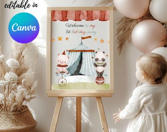May include: A printable sign for a 1st birthday party with a circus theme. The sign features a pink pig riding a unicycle and a panda bear balancing a ball. The text on the sign reads "Welcome to my 1st birthday party".