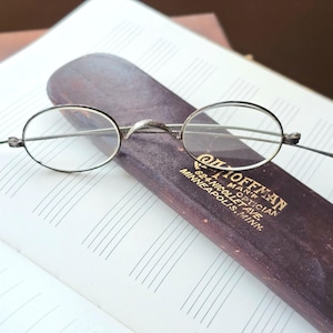 May include: A white ceramic mug with a black handle and the text "But First, Coffee" in a handwritten style. The mug is likely for hot beverages and has a glossy finish.