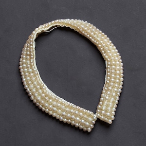 May include: A set of three ceramic mugs with a speckled, matte finish. The mugs are in shades of cream, light gray, and dark gray. Each mug has a simple, minimalist design and a rounded handle. The mugs are stacked on top of each other.