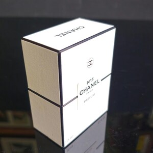 May include: A white rectangular box with black trim and the CHANEL logo on top. The front of the box displays the Chanel No. 5 logo, the word PARFUM, and the size 15 ml.