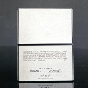 May include: A white rectangular box with black trim, featuring the Chanel logo and product information. The box includes a list of ingredients and the text "MADE IN FRANCE". The product is Chanel N&deg;5.
