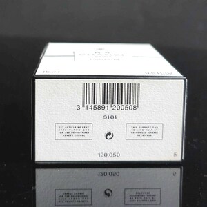 May include: A white rectangular box with black text and a barcode. The box has the text "CHANEL" and "N&deg;5 PARFUM" printed on it. The box also has the text "15 ml" and "0.5 FL. OZ."