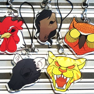May include: Six colourful animal head keychains with black string lanyards. The keychains feature a red rooster, a brown horse, an orange owl, a black rat, a yellow tiger, and a white and black cat.