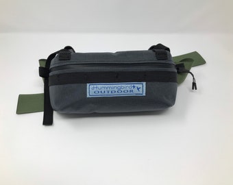 Little bum pack-grey. Same as a fanny pack, waist pack, or lumbar pack.