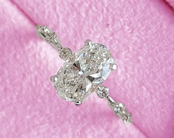 May include: A silver ring with an oval-shaped diamond in a pink velvet ring box.