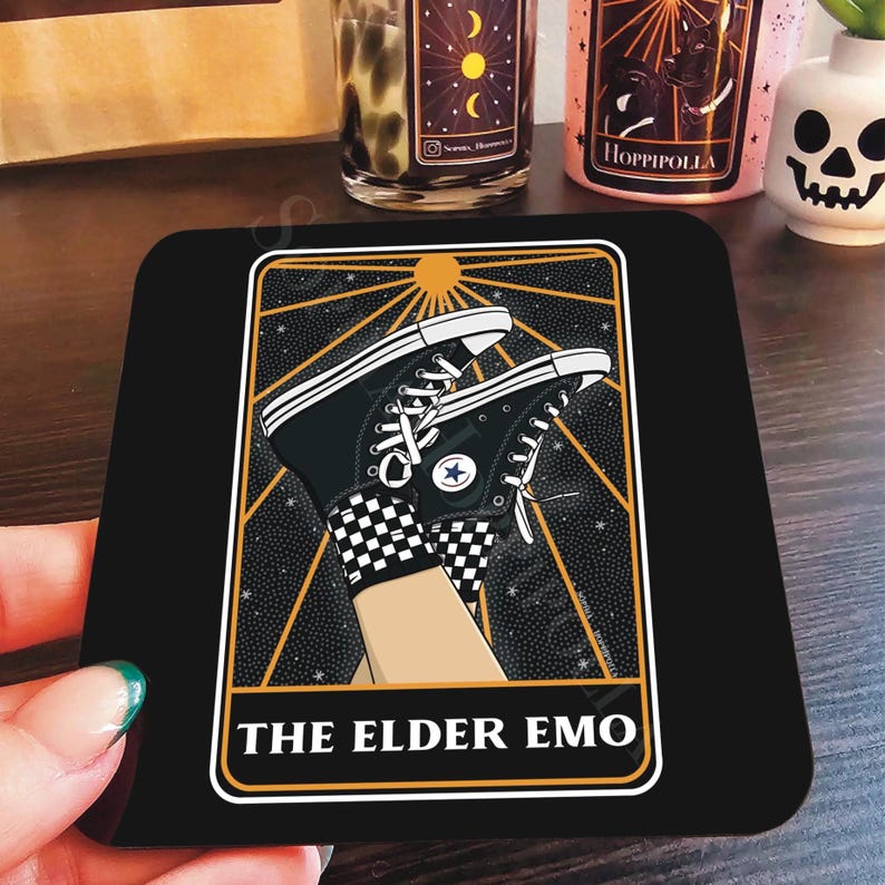 May include: Black and white illustration of a tarot card with the text "The Elder Emo" on a black background. The card features a pair of black and white Converse sneakers with a star on the side.