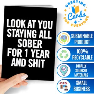 May include: A black greeting card with white text that reads, LOOK AT YOU STAYING ALL SOBER FOR 1 YEAR AND SHIT. The card is rectangular with a clean, bold font and a matte finish, presenting a straightforward design for a sobriety milestone celebration.