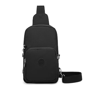 May include: A black nylon crossbody bag with a zippered pocket and a small circular logo on the front. The bag has a single adjustable strap.