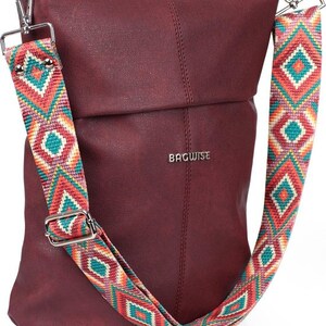 May include: A burgundy faux leather crossbody bag with a colorful geometric patterned strap. The strap is adjustable and has a silver buckle. The bag has a flap closure and the brand name "BAGWISE" is printed on the front.