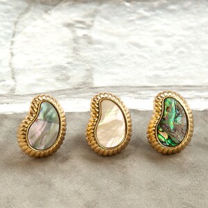 May include: Three gold-toned earrings with a pearlescent shell inlay. The earrings are in the shape of a teardrop with a rope-like border.