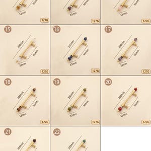 Op de afbeelding: Een verzameling messing kastgrepen, elk met een decoratieve kraal in een andere kleur. De grepen zijn 200 mm lang, 96 mm uit elkaar en 33 mm breed. De afbeelding bevat de tekst "127G".
