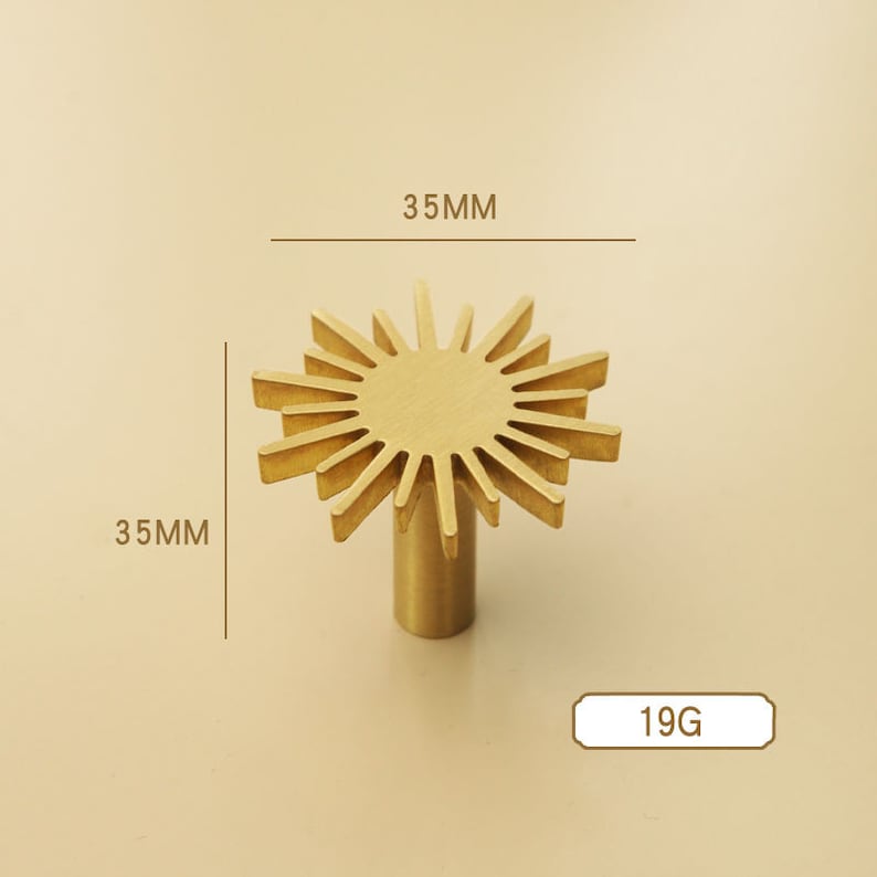May include: Gold-toned metal cabinet knob with a sunburst design. The knob measures 35mm in diameter and weighs 19 grams.